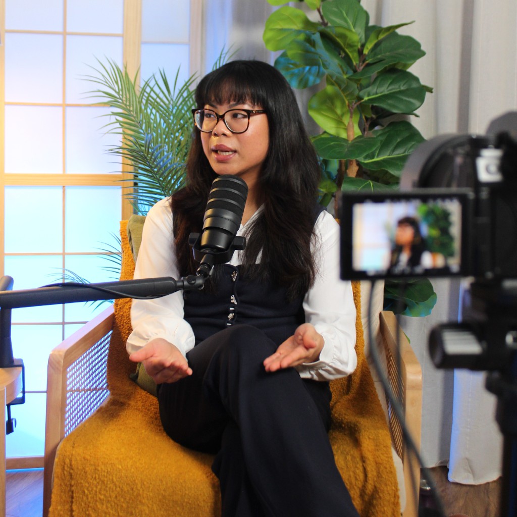 Guest speaking into a microphone while being filmed for the Investate podcast