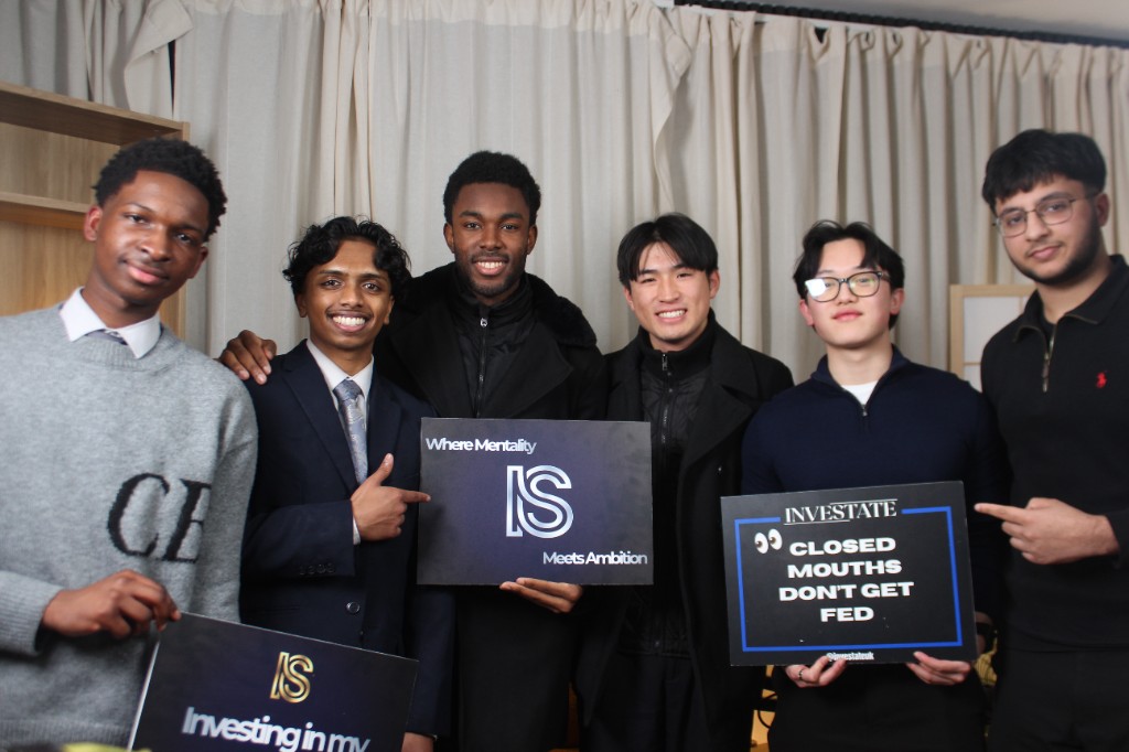 Team photo with Investate boards after a studio session